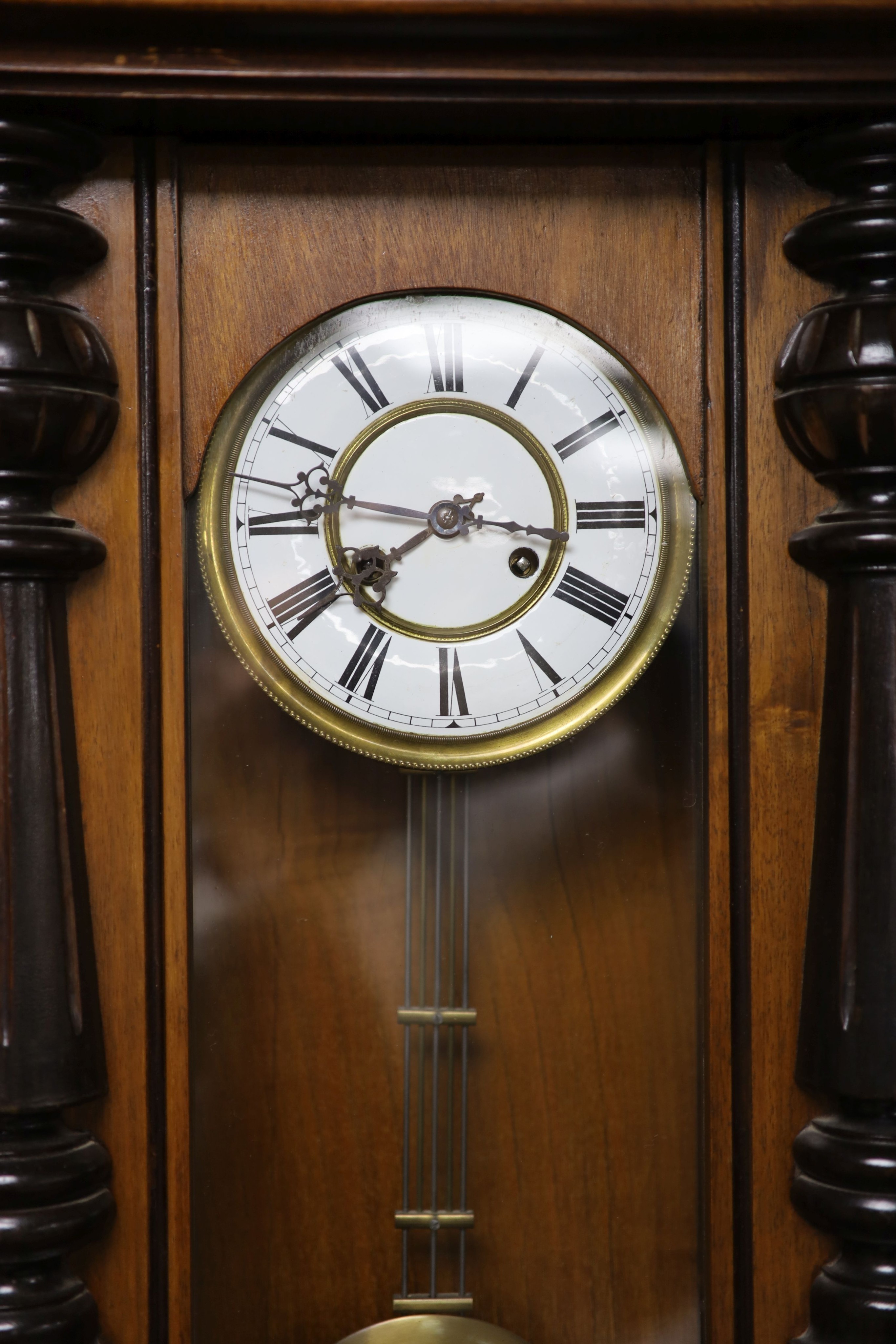 A 19th century Continental regulator in architectural walnut case, with key and gridiron pendulum, 116cm